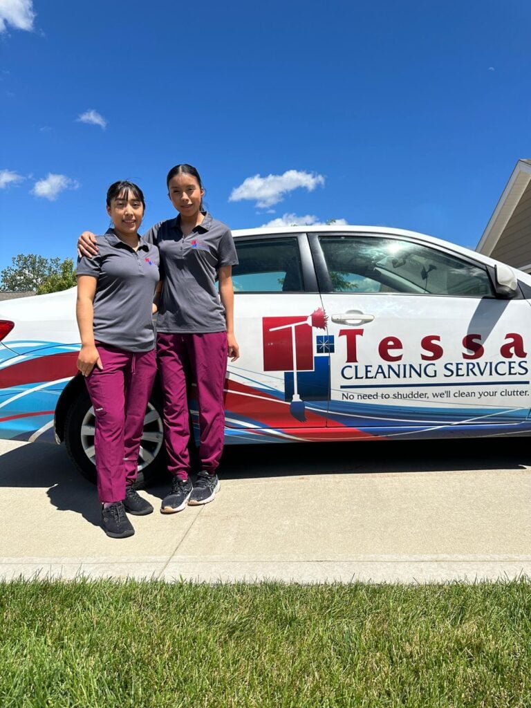 tessa cleaning team posing in front of company car
