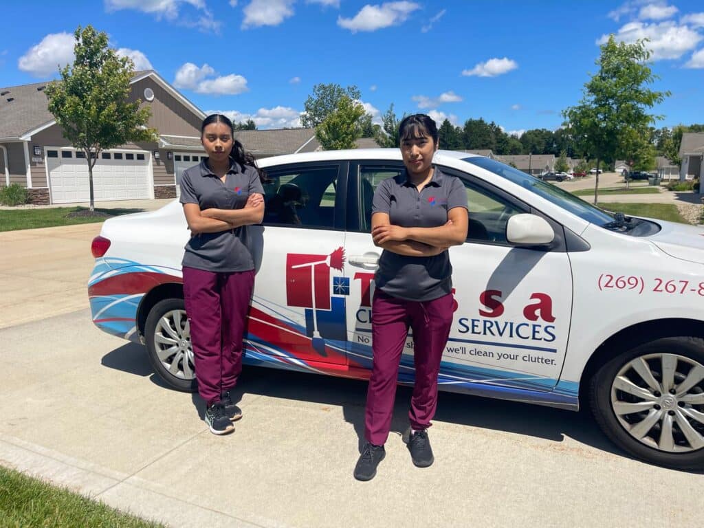 tessa cleaning workers posing in front of company car