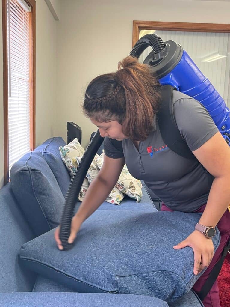 Tessa cleaning Services doing deep cleaning service with vacuum in house