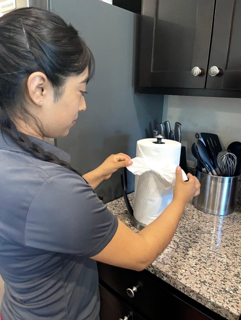 tessa cleaning worker fixing paper towel